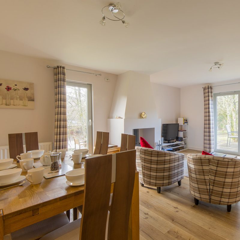 The open plan living and dining area in Taigh Nan Caorach accommodation at Abbey Holidays Loch Ness