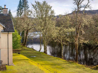 Exterior Courtyard Cottage 8 The exterior of Taigh Nan Caorach accommodation at Abbey Holidays Loch Ness by the banks of the water