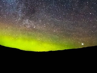 The Aurora Borealis over the Scottish Highlands