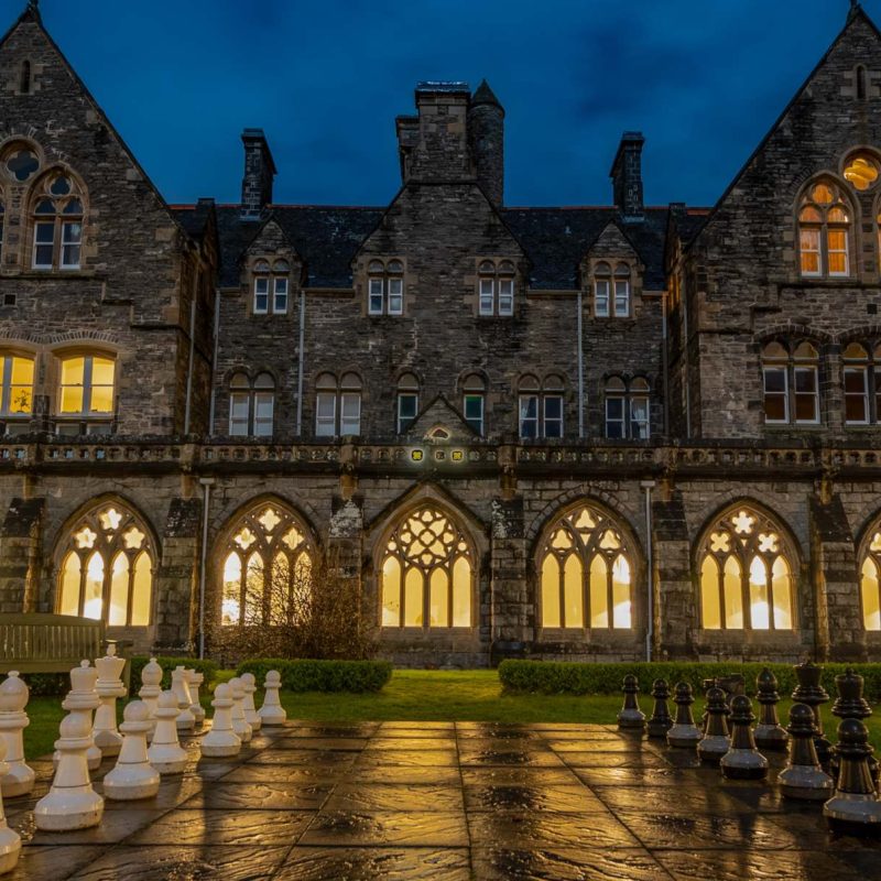 The cloisters garden at night with outdoor giant chess.