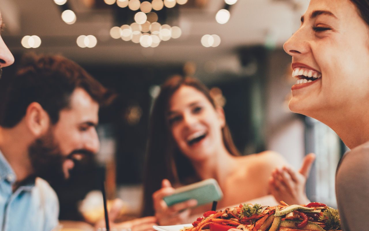 Happy people eating out at a restaurant