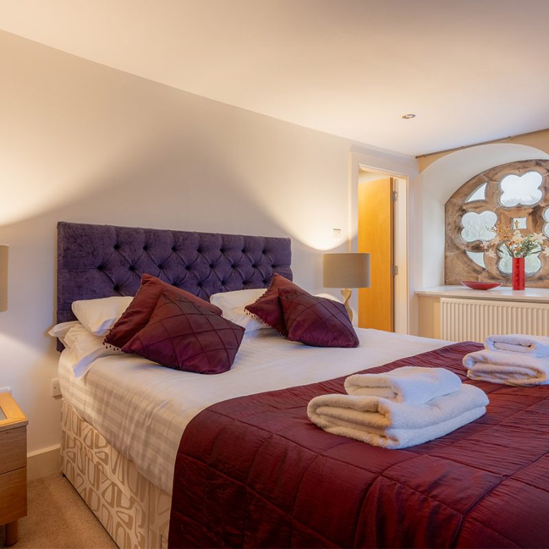 A double room with a stunning rose window in The Ross accommodation at Abbey Holidays in Loch Ness