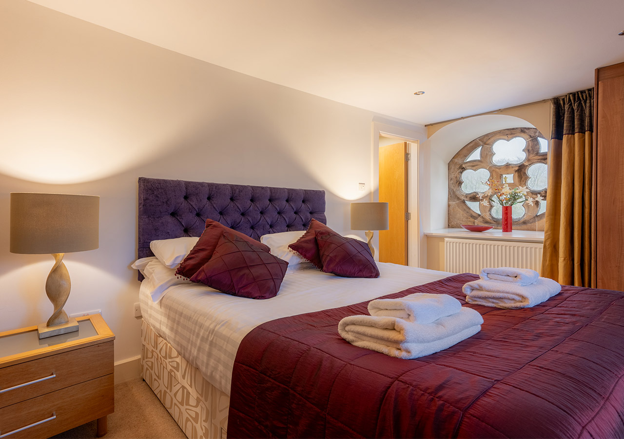 A double room with a stunning rose window in The Ross accommodation at Abbey Holidays in Loch Ness