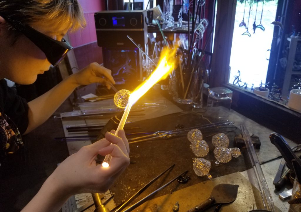 Crafter working in glass blowing studio