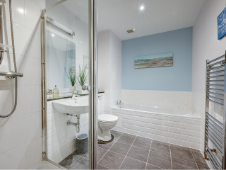 Abbey Church 24 Upper North Aisle Bathroom Abbey Church 24 - Upper North Aisle accommodations bathroom with separate shower and bath at Abbey Holidays by Loch Ness