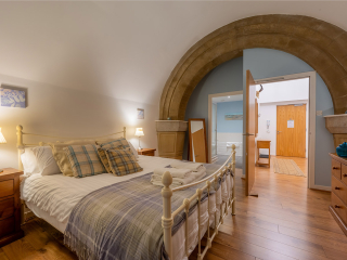 Abbey Church 24 Upper North Aisle Double Bedroom Abbey Church 24 - Upper North Aisle accommodations double room with spectacular arch at Abbey Holidays by Loch Ness