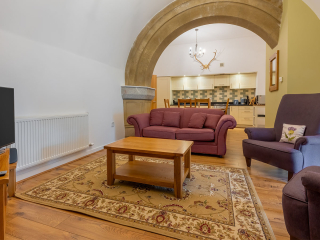 Abbey Church 24 Upper North Aisle Living Room Abbey Church 24 - Upper North Aisle accommodations living room with spectacular arch at Abbey Holidays by Loch Ness