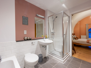Abbey Church 25 - The Dunfermline accommodations bathroom with separate shower and bath at Abbey Holidays by Loch Ness