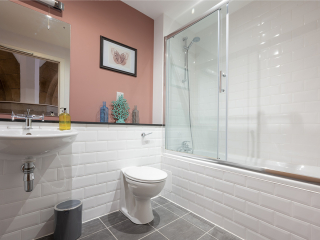 Abbey Church 25 - The Dunfermline accommodations bathroom with shower over the bath at Abbey Holidays by Loch Ness
