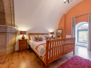 Abbey Church 25 - The Dunfermline accommodations double bedroom with stunning stone arch at Abbey Holidays by Loch Ness