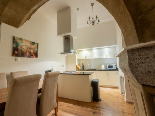 Abbey Church 25 - The Dunfermline accommodations kitche and dining room with stunning stone arch at Abbey Holidays by Loch Ness