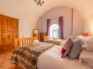 Abbey Church 25 - The Dunfermline accommodations arched twin bedroom at Abbey Holidays by Loch Ness