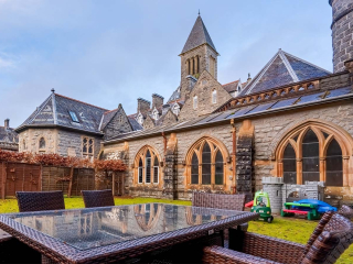 The exterior with garden and garden furniture at Abbey Church 9 The Nave at Abbey Holidays by Loch Ness
