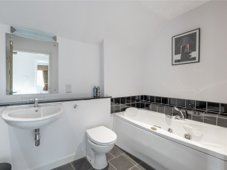 Courtyard Cottage 2 Club Cottage bathroom with bath at Abbey Holidays by Loch Ness