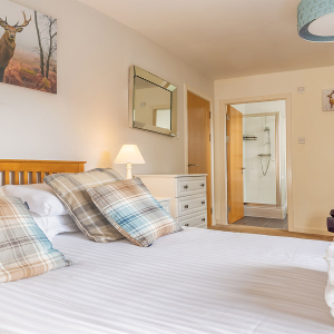 Courtyard Cottage 4 - Brora accommodation&#039;s double bedroom with en-suite at Abbey Holidays Loch Ness