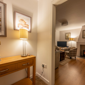 Courtyard Cottage 4 - Brora accomodation&#039;s hallway leading into the living room at Abbey Holidays Loch Ness