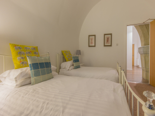 Glen Affric Abbey Church 22 Twin Room Abbey Church 22 - Glen Affric accommodations arched twin bedroom at Abbey Holidays by Loch Ness