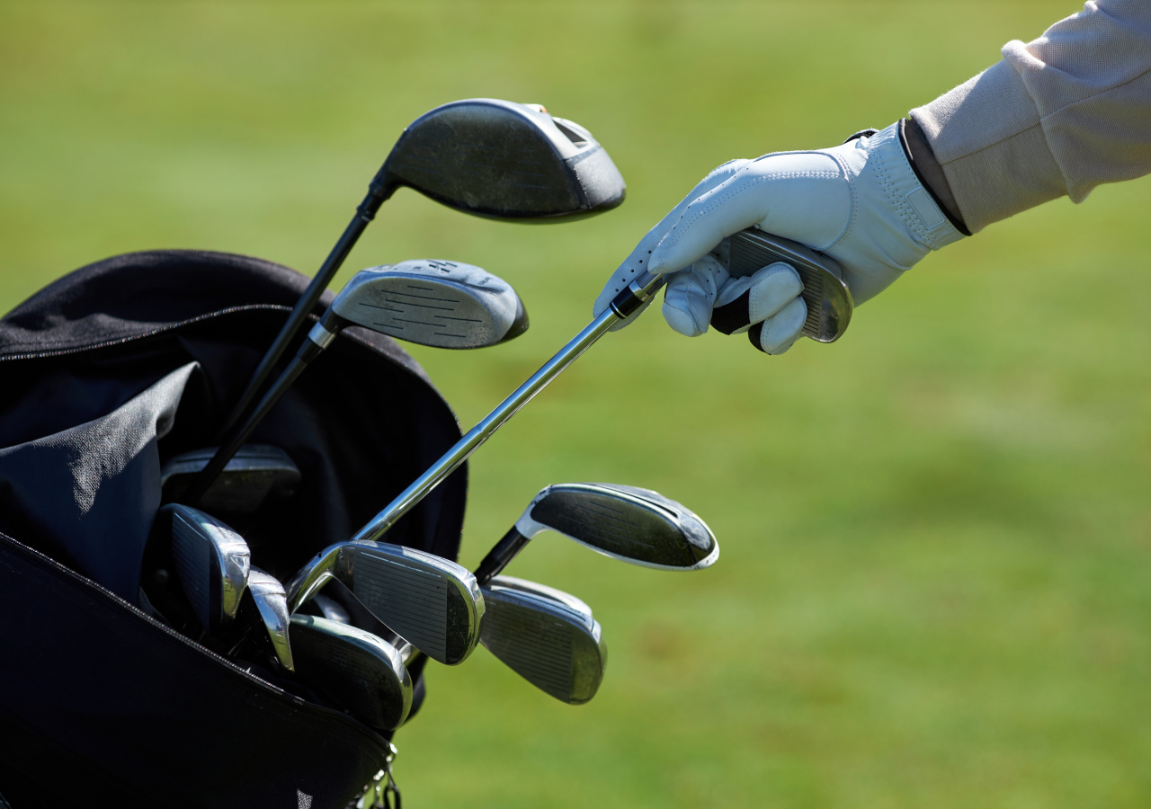 Golfer choosing club and it taking out of golf bag