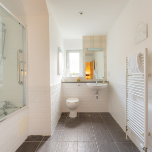 Courtyard Cottage 11 - Strath Glass accommodation&#039;s bathroom with shower over bath at Abbey Holidays Loch Ness