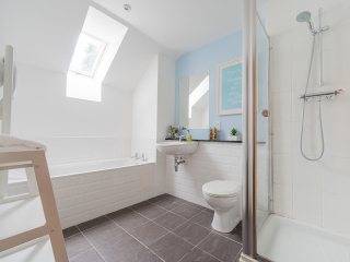 Strath Glass accommodation&#039;s bathroom separate shower over bath at Abbey Holidays Loch Ness