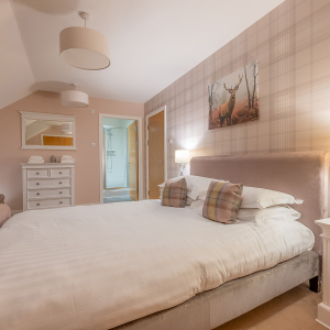 Strath Glass accommodation&#039;s double bedroom with en-suite at Abbey Holidays Loch Ness