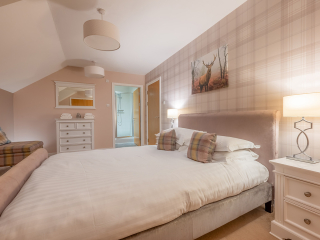 Strath Glass accommodation&#039;s double bedroom with en-suite at Abbey Holidays Loch Ness