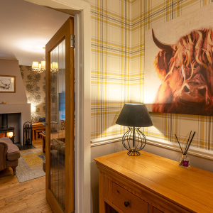 Strath Glass accommodation&#039;s hall leading into living room at Abbey Holidays Loch Ness