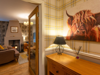 Strath Glass accommodation&#039;s hall leading into living room at Abbey Holidays Loch Ness