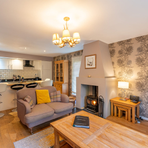 Strath Glass accommodation&#039;s open plan living with burning stove at Abbey Holidays Loch Ness