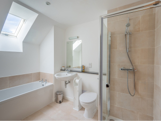 Courtyard Cottage 8 - Taigh Nan Caorach accommodation&#039;s bathroom with separate bath and shower at Abbey Holidays Loch Ness