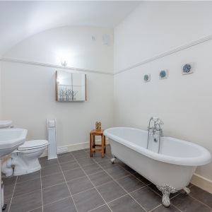 Moat House 2 - Major&#039;s Apartment accommodation&#039;s bathroom with roll top bath at Abbey Hoildays Loch Ness