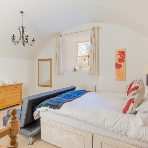 Moat House 2 - Major&#039;s Apartment accommodation&#039;s double bedroom with arched wall at Abbey Hoildays Loch Ness