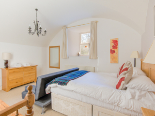 Moat House 2 - Major&#039;s Apartment accommodation&#039;s double bedroom with arched wall at Abbey Hoildays Loch Ness
