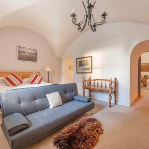 Moat House 2 - Major&#039;s Apartment accommodation&#039;s double bedroom with arched wall at Abbey Hoildays Loch Ness