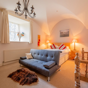 Moat House 2 - Major&#039;s Apartment accommodation&#039;s double bedroom with arched wall at Abbey Hoildays Loch Ness
