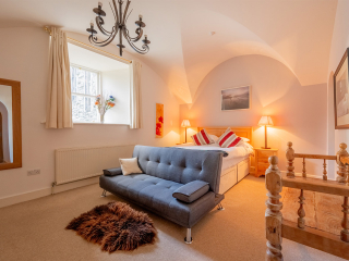 Moat House 2 - Major&#039;s Apartment accommodation&#039;s double bedroom with arched wall at Abbey Hoildays Loch Ness