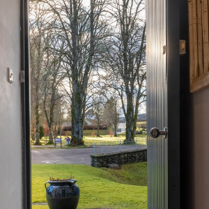 Moat House 2 - Major&#039;s Apartment accommodation&#039;s view out of front door onto tree lined grounds at Abbey Hoildays Loch Ness