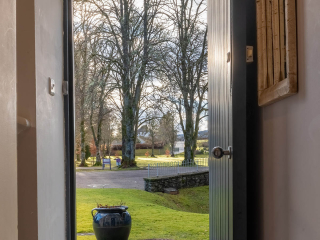 Moat House 2 - Major&#039;s Apartment accommodation&#039;s view out of front door onto tree lined grounds at Abbey Hoildays Loch Ness