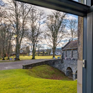 Moat House 2 - Major&#039;s Apartment accommodation&#039;s view out of front door onto tree lined grounds at Abbey Hoildays Loch Ness
