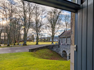 Moat House 2 - Major&#039;s Apartment accommodation&#039;s view out of front door onto tree lined grounds at Abbey Hoildays Loch Ness