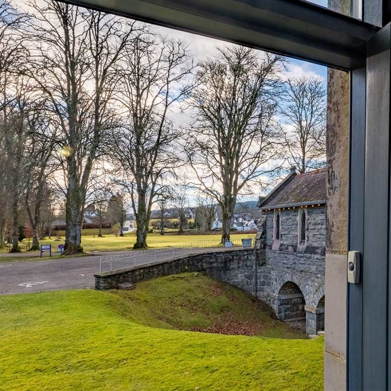 Moat House 2 - Major's Apartment accommodation's view out of front door onto tree lined grounds at Abbey Hoildays Loch Ness