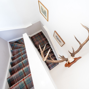 Moat House 2 - Major&#039;s Apartment accommodation&#039;s stariwell with deer antlers on the wall at Abbey Hoildays Loch Ness