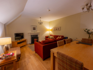 Moat House 5 The Ross accommodation&#039;s living dining room at Abbey Holidays Loch Ness