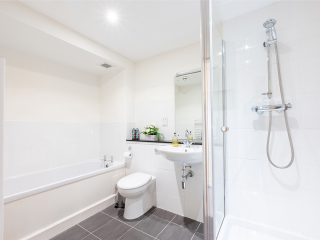 Monastery 10 - Brunel accommodation&#039;s bathroom with separate bath and shower at Abbey Holidays Loch Ness