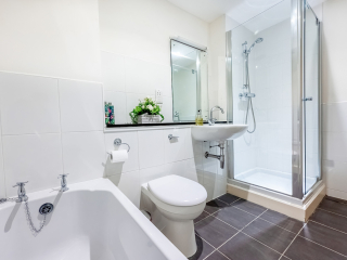 Monastery 10 - Brunel accommodation&#039;s bathroom with separate bath and shower at Abbey Holidays Loch Ness