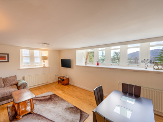 Monastery 10 - Brunel accommodation&#039;s open plan living and dining with stunning views of Loch Ness from the window at Abbey Holidays Loch Ness