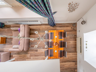 The Caledonian - Old School 12 accommodation&#039;s view down to the open plan living area from the above bedroom mezzanine at Abbey Holidays Loch Ness