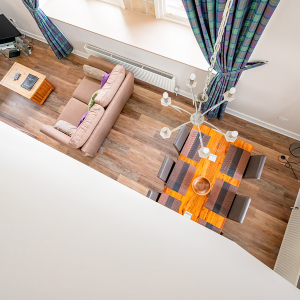 The Caledonian - Old School 12 accommodation&#039;s view down to the open plan living area from the above bedroom mezzanine at Abbey Holidays Loch Ness