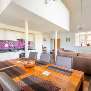 The Caledonian - Old School 12 accommodation&#039;s open plan living area with mezzanine housing the double bedroom at Abbey Holidays Loch Ness