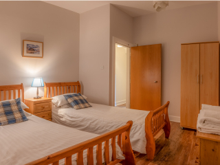 The Caledonian - Old School 12 accommodation&#039;s twin bedroom at Abbey Holidays Loch Ness